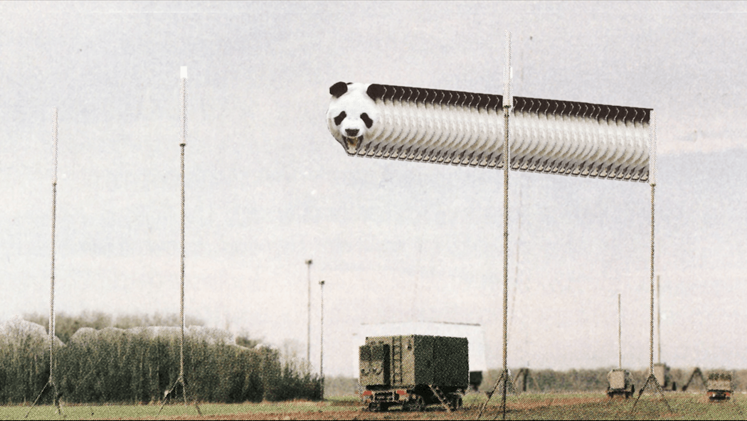 A magazine cutout of a field with a square green truck in the middle with a panda's head, repeated several times and appearing overhead