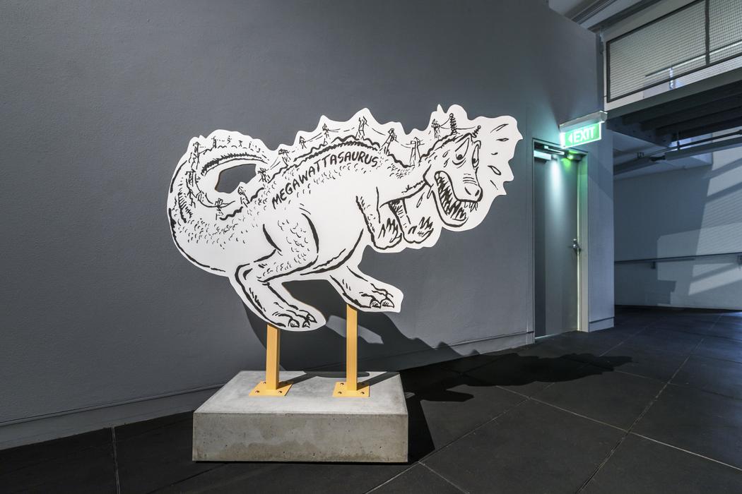 A cut-out cartoon of a dinosaur, with power pylons running along its back with the word 'Megawattasaurus'