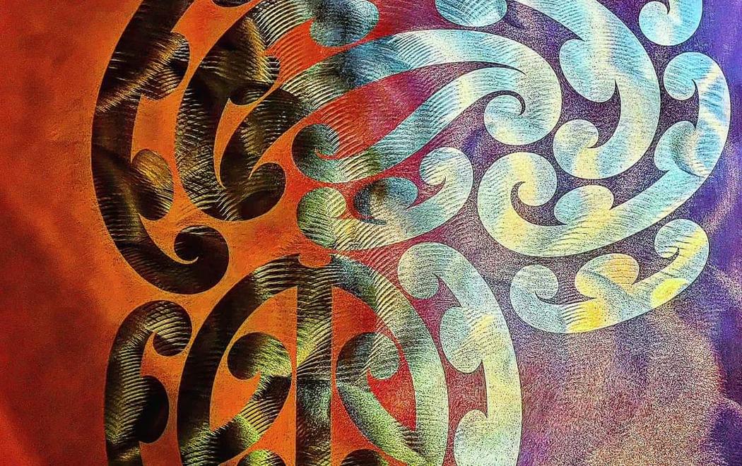 A graphic kowhaiwhai pattern against a luminous orange and purple background