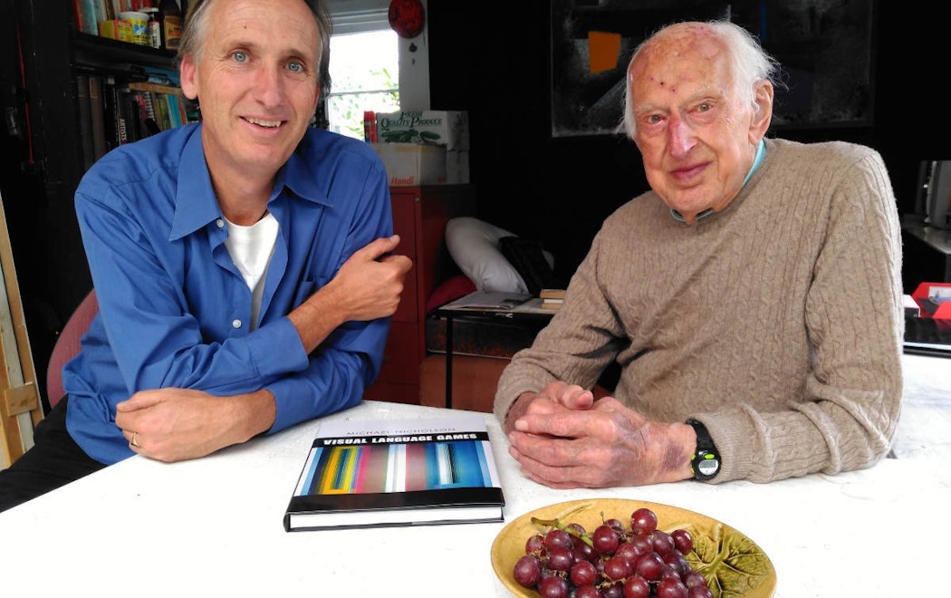 Mark Amery and Michael Nicholson sit at a kitchen table with a bowl of grapes near them