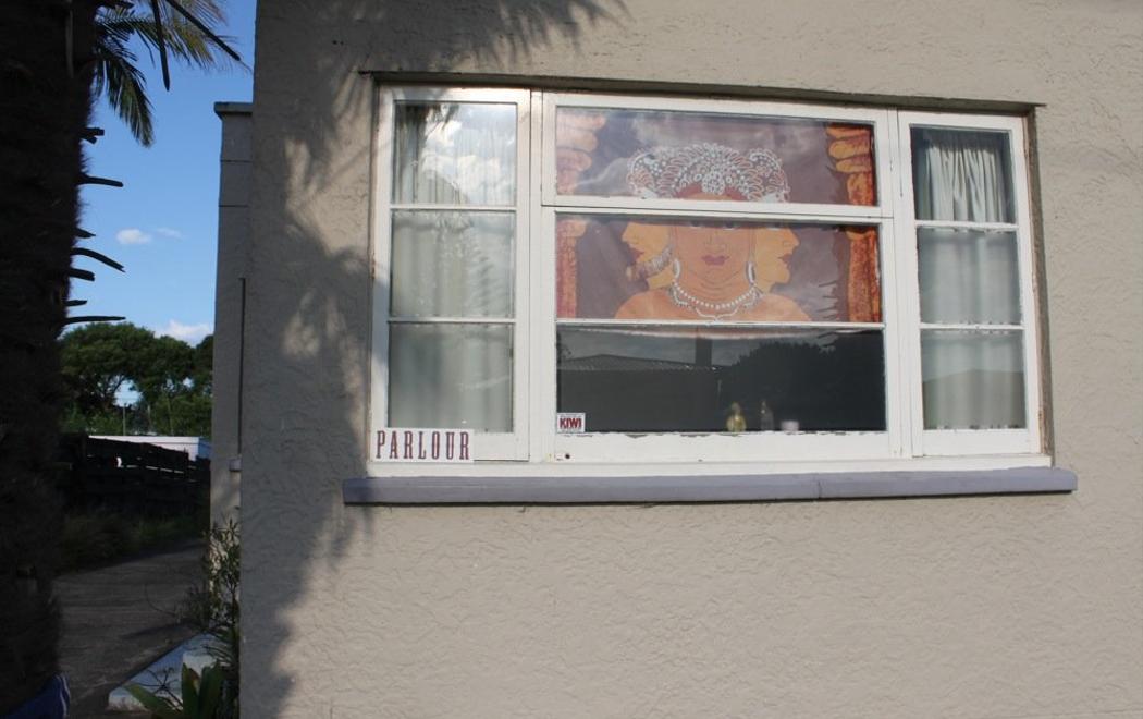 The outside of a house with a small sign reading "parlour"