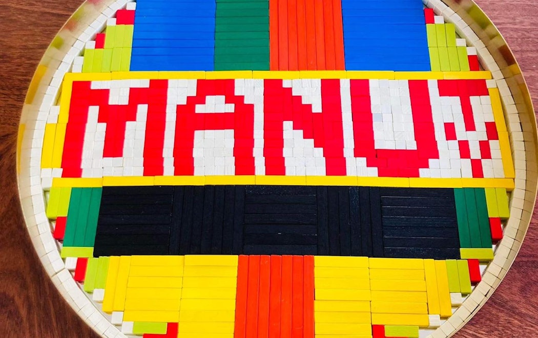 A group of cuisenaire rods show a bright TV test pattern and the words MANU TV