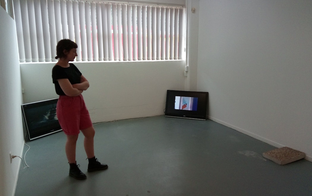 Priscilla Howe is standing in a gallery contemplating the installation of the artworks