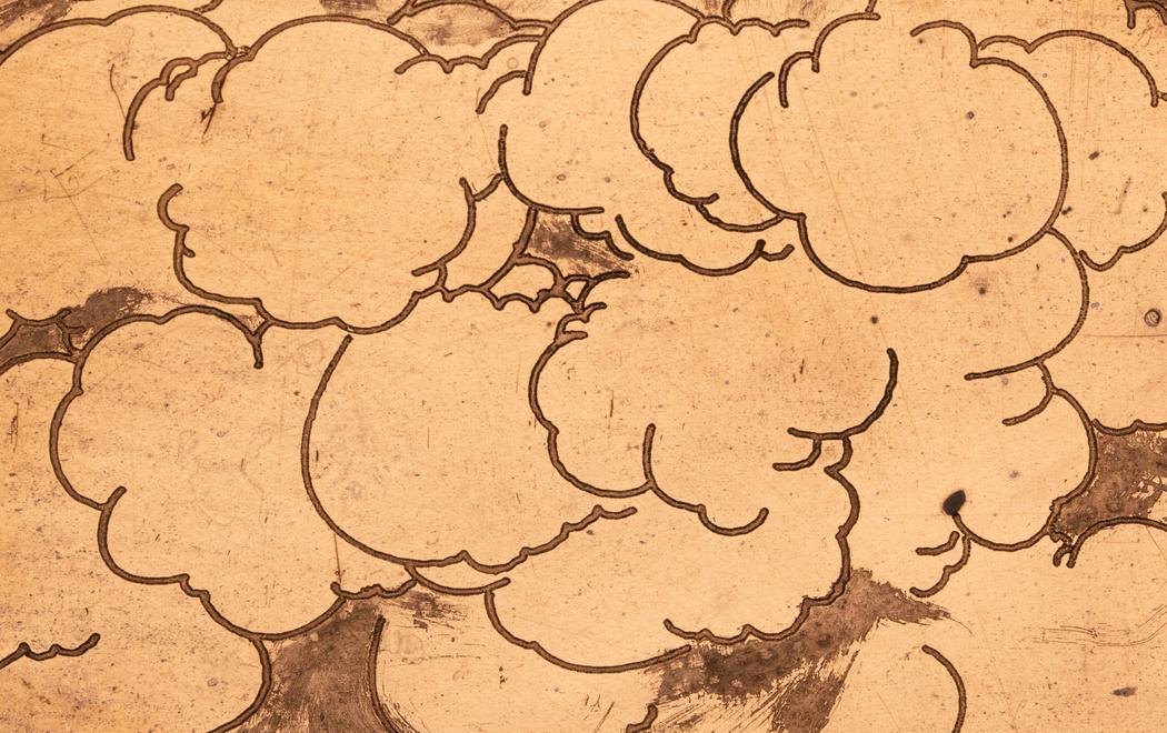 Cartoon clouds form a mass on a copper surface
