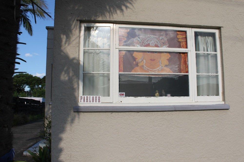 The outside of a house with a small sign reading "parlour"