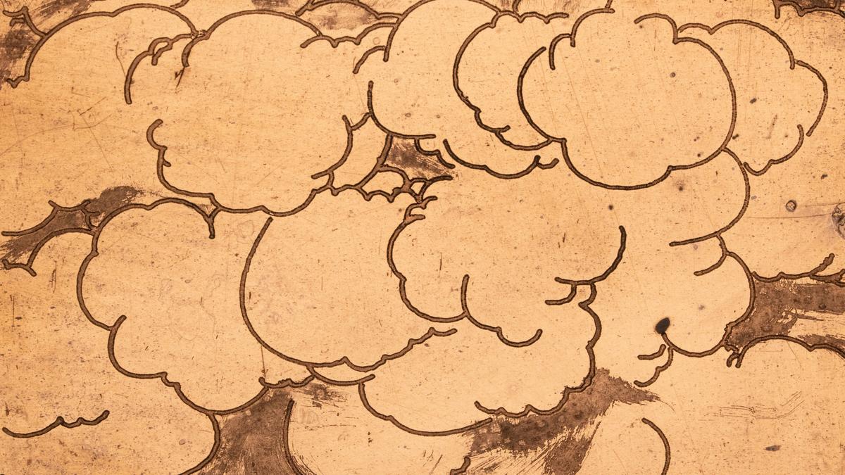 Cartoon clouds form a mass on a copper surface