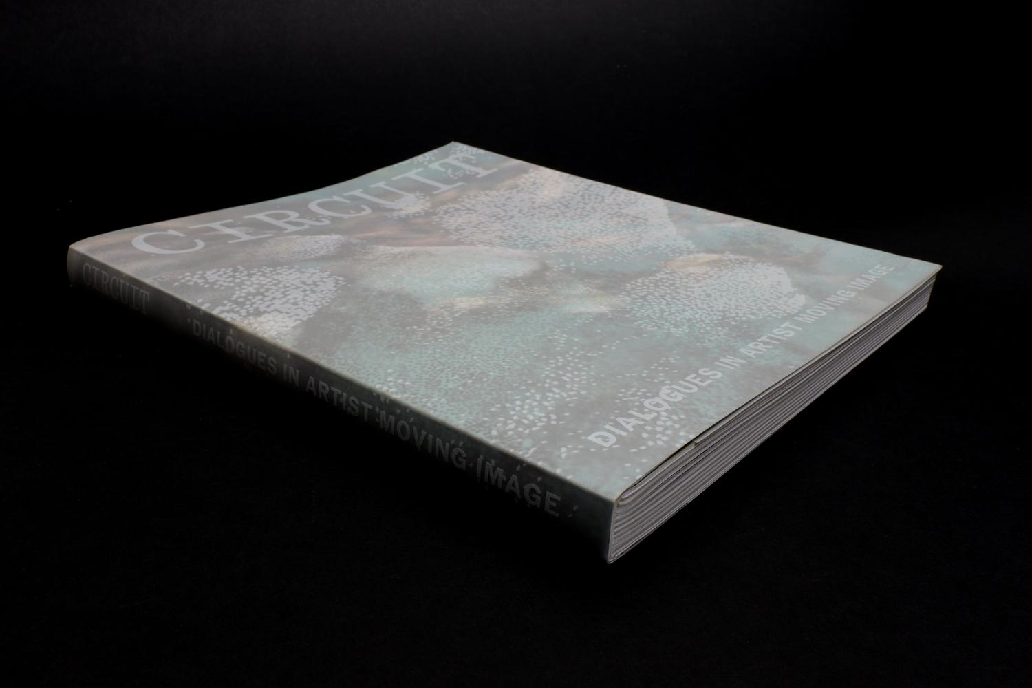 A picture of a book showing abstract pointiliistic form son it's cover, and the title CIRCUIT Dialogues in Artist Moving Image