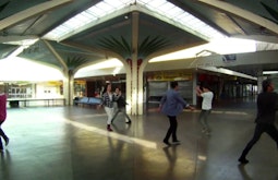 A group of dancers perform in an empty mall.