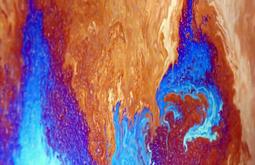 A neon blue and orange colours cape of liquid seen extremely close up