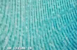 An extremely close up view of a TV screen, the pixels making abstract lines and patterns.