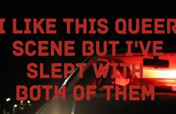 People sit in a parked car with red light illuminating the interior. On screen there is text reading, I like this queer scene but I've slept with both of them.