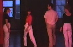 Four people walk around one another in choreographed movements.