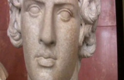 A close up of a stone statue's face.