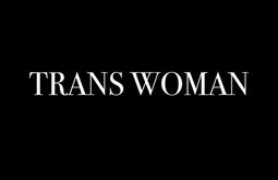 The tex 'TRANS WOMAN' is written in white across a black background.