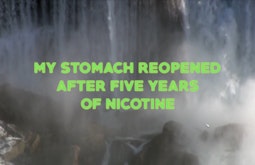 A waterfall crashes onto rocks. Neon green text reading "My stomach reopened after fives years of nicotine" is overlayed.