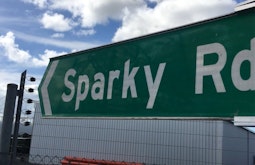 A large location sign reading 'Sparky Rd' that points to the left.