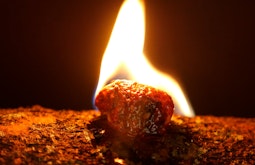 A close up of a small rock that is on fire.