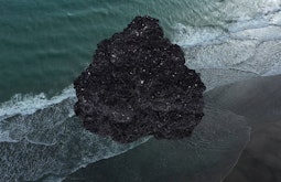 A crystal formation is super-imposed onto a birds eye view of the sea.