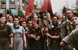 A crowd of soldiers holding guns and flags stand looking at the camera, their faces have been digitally imposed onto the bodies.