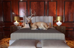 A digitally rendered scene of a large deer resting on a king sized bed in a luxurious bedroom.