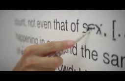 A person scribbles out of the word sex from a sentence.