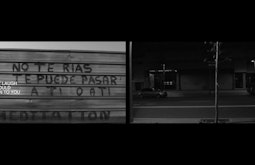 In screen one, Spanish graffiti on a metal roller door is translated in English text on screen as 'Don't laugh this could happen to you'. In screen 2 we see an empty street at night with a car at left and single thin tree in the foreground.