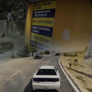 A composite digital image showing three scenes blurred into each other; a video game scene of a car on a highway; advertising for food takeaways on the side of a corner store; roadworks