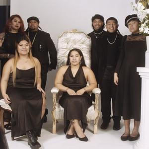 A group portrait of an extended family in a photo studio