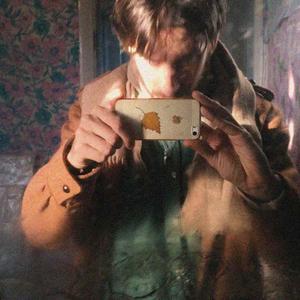 Martin takes a selfie in an old mirror with their iphone