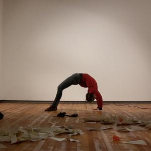 Melissa performs a bridge pose in a gallery