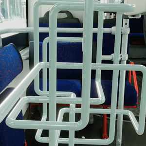 The interior of a bus or tram that is filled with a white tube that loops around to form an overlapping knot. The tube is similar in appearance to the bus's safety rail.