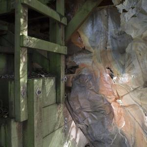 Biofilm, an eco plastic, is hung against wood under a deck