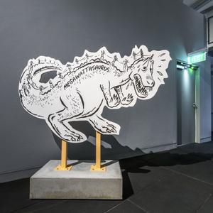 A cut-out cartoon of a dinosaur, with power pylons running along its back with the word 'Megawattasaurus'