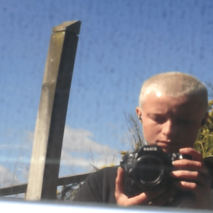 Jo Bragg photographs their self reflection in a car window