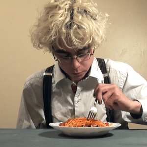 Theo is dressed as David Bowie with bleached hair, button up shirt with suspenders, eats canned spaghetti