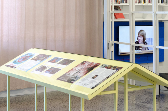 Selected ephemera is presented in yellow vitrine.