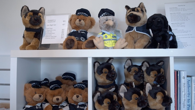 A group of soft toy police dogs on shelves