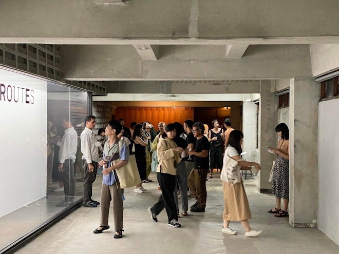 A group of people at a gallery opening in Thailand.