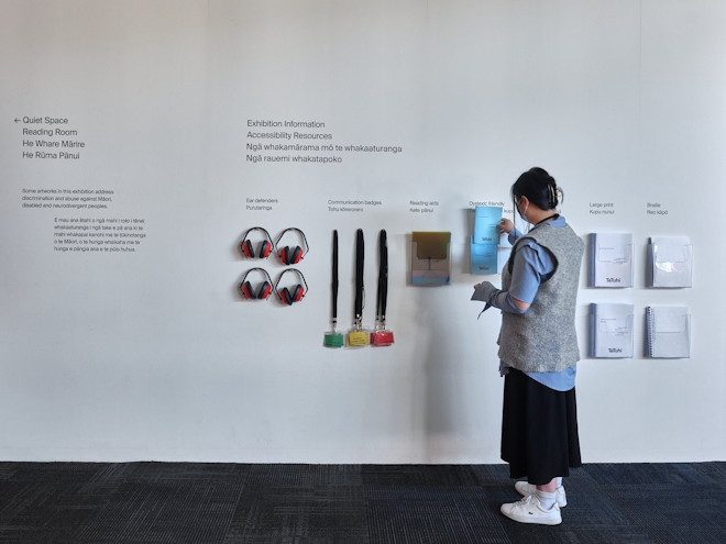 An installation shot of a gallery information wall with accessibility resources