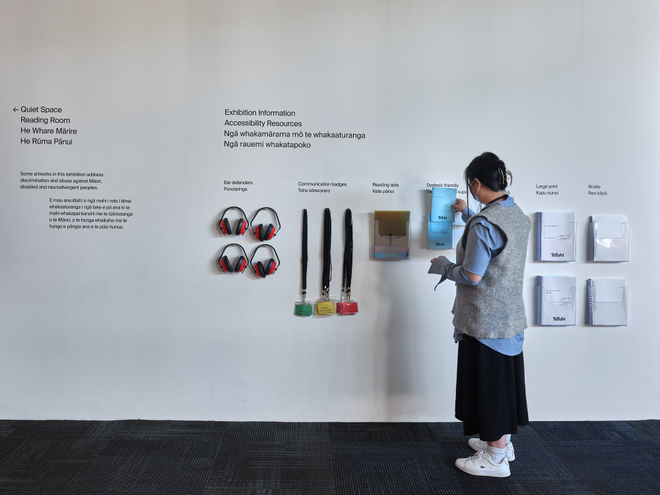 An installation shot of a gallery information wall with accessibility resources