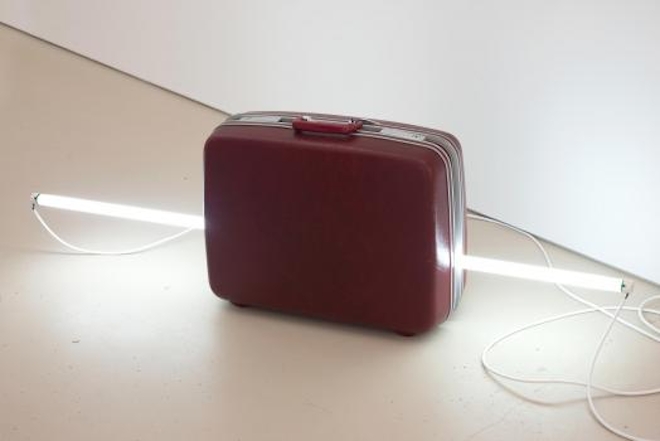 a suitcase with a light tube through it