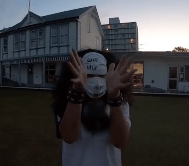 Suzanne Tamaki wearing a full face mask at Newtown Bowling Club at dusk