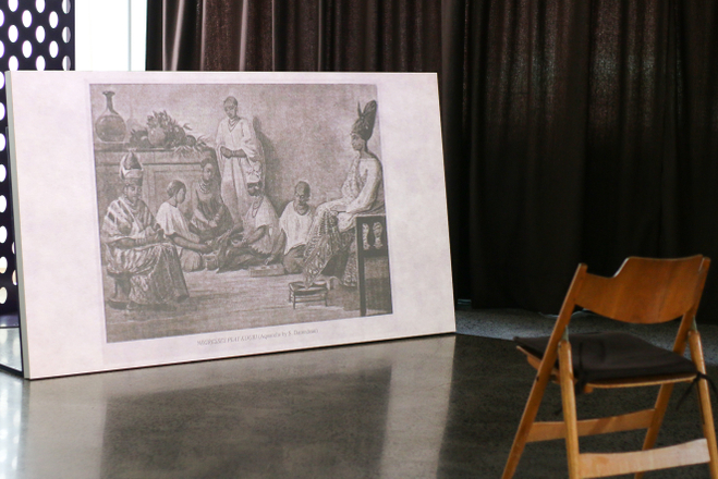 A 19th century etching of 'negresses play kouri' shows on a film screen